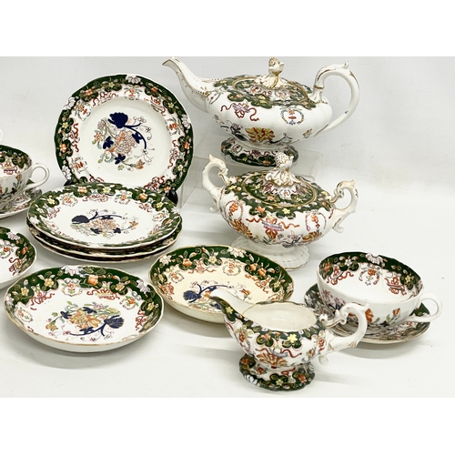 605 - 18 pieces of mid 19th century Victorian dinner ware. Teapot measures 28cm.