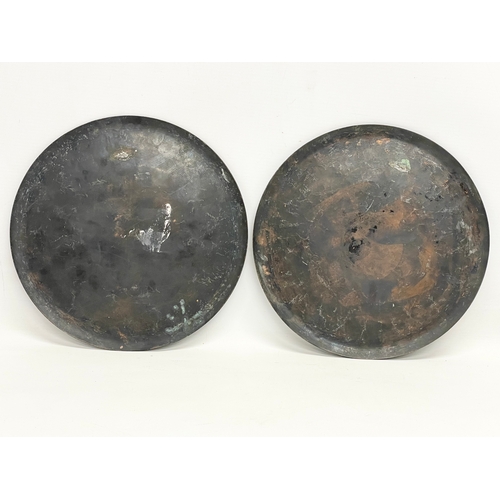 64 - A pair of late 19th century silver plated inlaid copper trays. 25cm