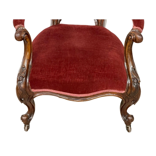 1040 - A Victorian rosewood gents parlour chair on Cabriole legs.