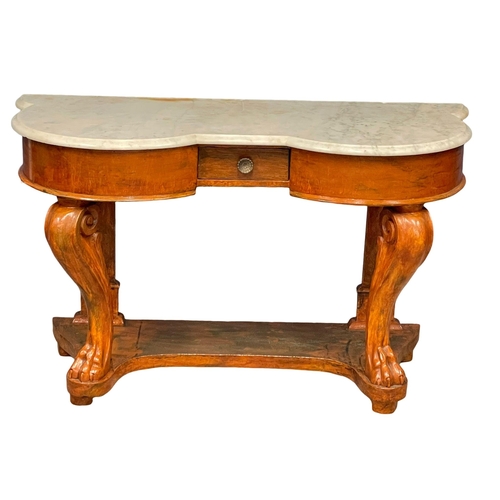 1042 - A Victorian mahogany marble top side table on lion paw feet.  121x50x73cm