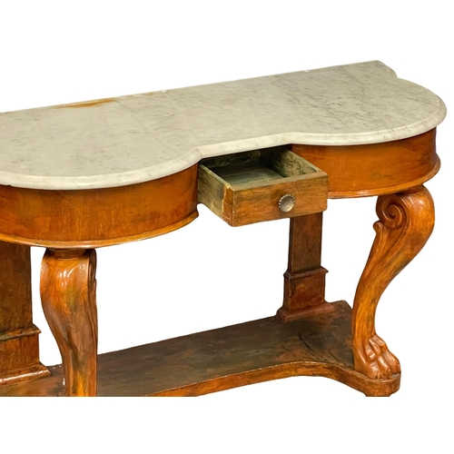 1042 - A Victorian mahogany marble top side table on lion paw feet.  121x50x73cm