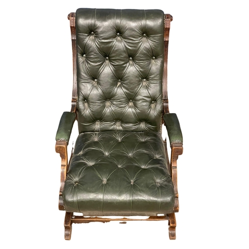 823 - A Victorian deep button leather rocking chair. Circa 1890.