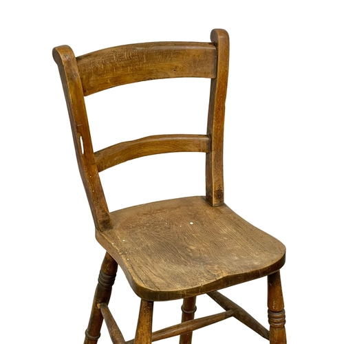 848 - A Victorian Elm and Beech clerks chair. 106cm