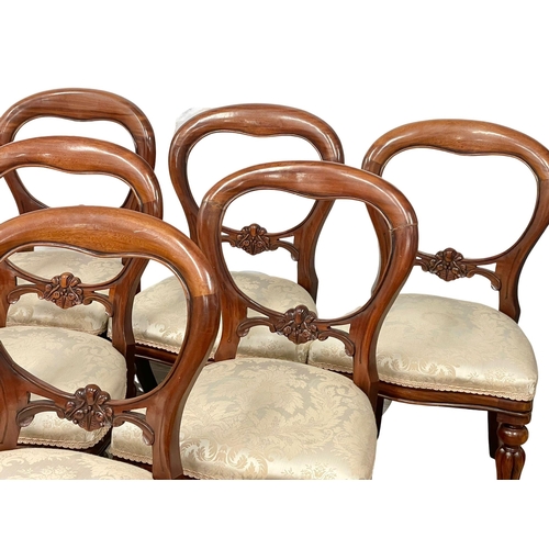 851 - A set of 9 Victorian style mahogany balloon back dining chairs on reeded legs.