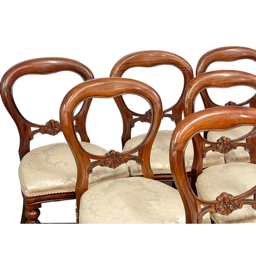 851 - A set of 9 Victorian style mahogany balloon back dining chairs on reeded legs.