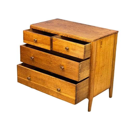 869 - An early to mid 20th century Heals style oak chest of drawers by Angus Menstrie. 91x50x82cm