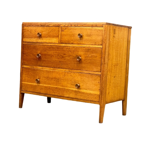 869 - An early to mid 20th century Heals style oak chest of drawers by Angus Menstrie. 91x50x82cm