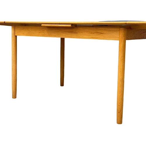 883 - A Danish Mid Century teak extending dining table. 1960’s. Open 221cm. Open 125.5x86x75.5cm.