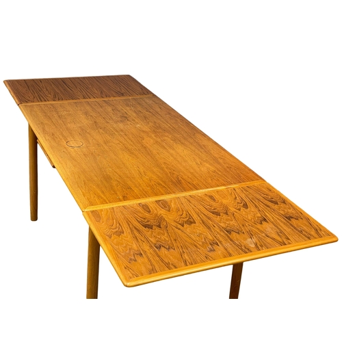 883 - A Danish Mid Century teak extending dining table. 1960’s. Open 221cm. Open 125.5x86x75.5cm.