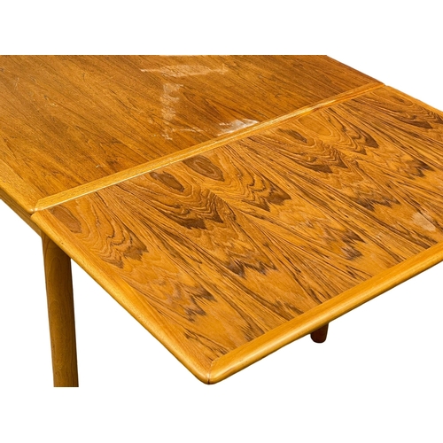 883 - A Danish Mid Century teak extending dining table. 1960’s. Open 221cm. Open 125.5x86x75.5cm.