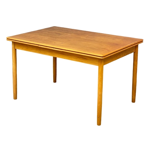 883 - A Danish Mid Century teak extending dining table. 1960’s. Open 221cm. Open 125.5x86x75.5cm.