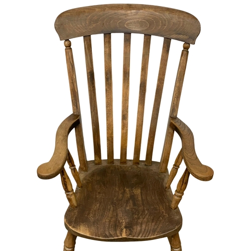 884 - A Victorian Elm and Beech high back kitchen armchair.