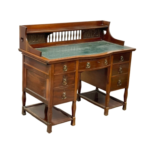 886 - A late Victorian Art Nouveau mahogany desk with leather top. 122x60x102cm.