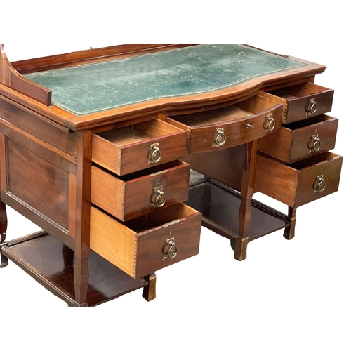 886 - A late Victorian Art Nouveau mahogany desk with leather top. 122x60x102cm.