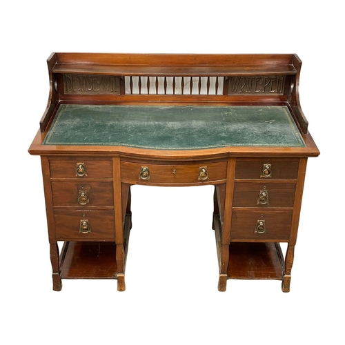 886 - A late Victorian Art Nouveau mahogany desk with leather top. 122x60x102cm.