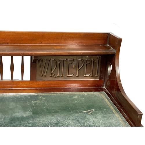 886 - A late Victorian Art Nouveau mahogany desk with leather top. 122x60x102cm.