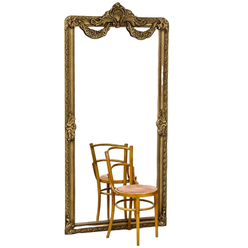 901 - A large ornate gilt framed mirror. 100x213cm