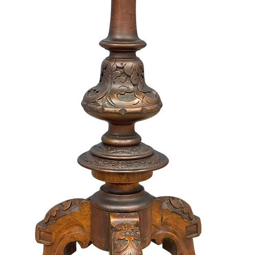 915 - A Victorian carved Walnut pedestal occasional table. 52x75cm