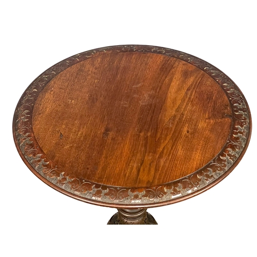 915 - A Victorian carved Walnut pedestal occasional table. 52x75cm