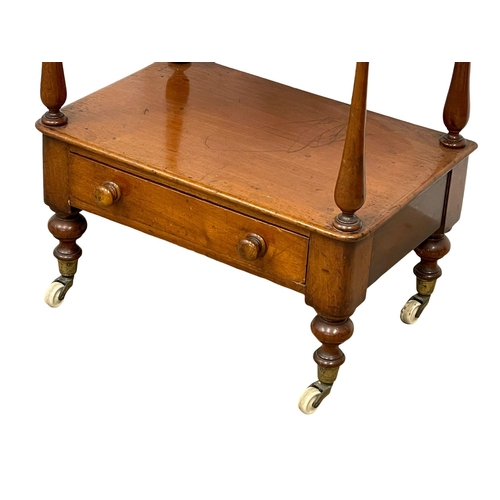 922 - A Victorian mahogany 3 tier whatnot with drawer on brass cup casters. 1860-1870 52x35x104cm