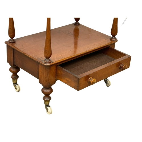 922 - A Victorian mahogany 3 tier whatnot with drawer on brass cup casters. 1860-1870 52x35x104cm