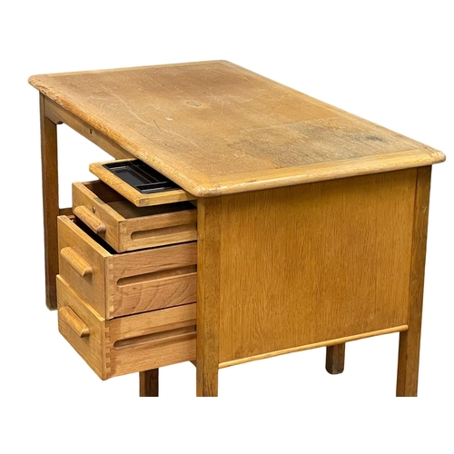 928 - A vintage oak desk by Abbess. 122x69x76cm