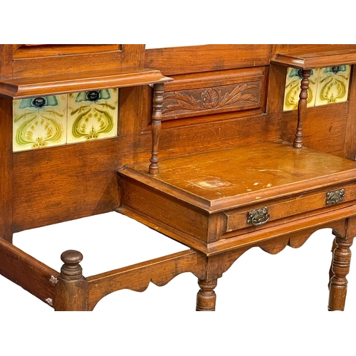 933 - A large Victorian oak hallstand with Art Nouveau tiles and original trays. Circa 1880. 131x36x212cm