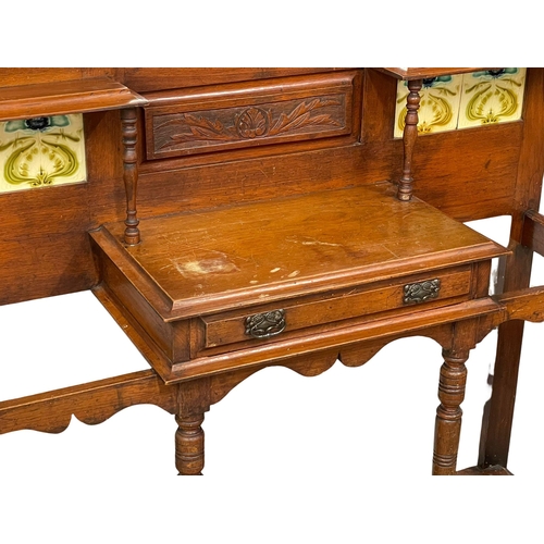 933 - A large Victorian oak hallstand with Art Nouveau tiles and original trays. Circa 1880. 131x36x212cm