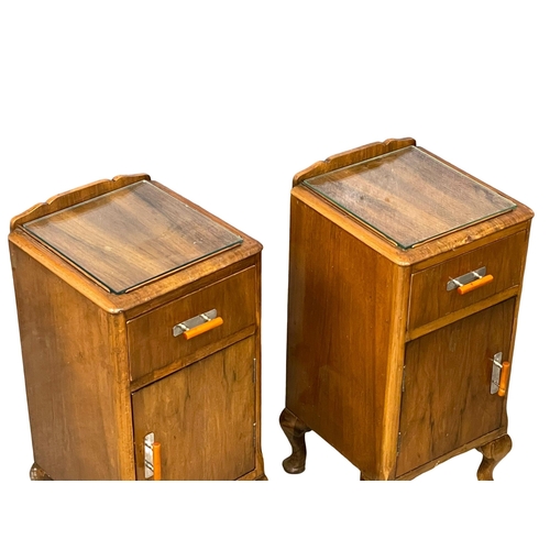 939 - A pair of vintage Walnut bedside cabinets with glass insert tops. 33x34x64cm.