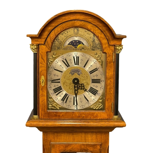 944 - A mahogany and burr walnut long case clock with brass moon dial face. By Warmink. Weights and pendul... 