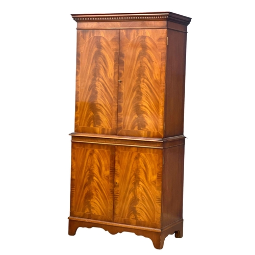 949 - A Georgian style flamed mahogany cocktail cabinet. 73x42x155cm