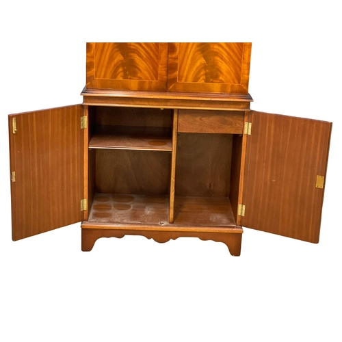 949 - A Georgian style flamed mahogany cocktail cabinet. 73x42x155cm