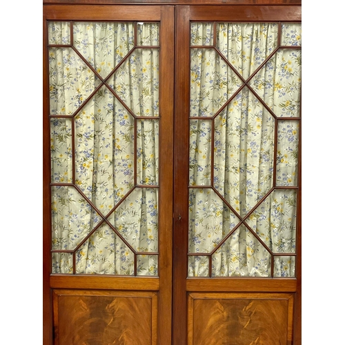 954 - A late Victorian mahogany double door wardrobe with astragal glazed doors. 133x59x214cm