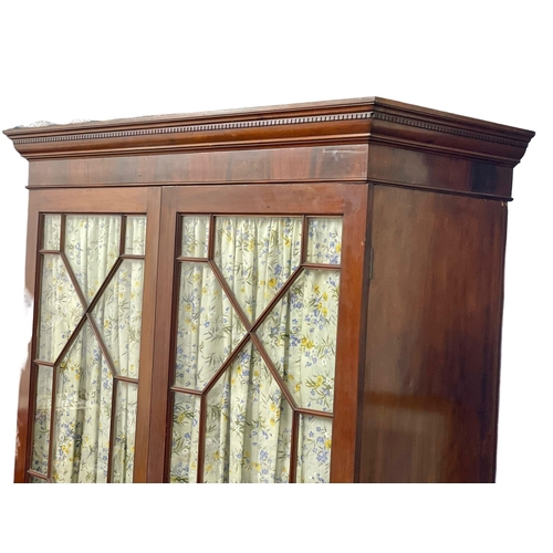 954 - A late Victorian mahogany double door wardrobe with astragal glazed doors. 133x59x214cm