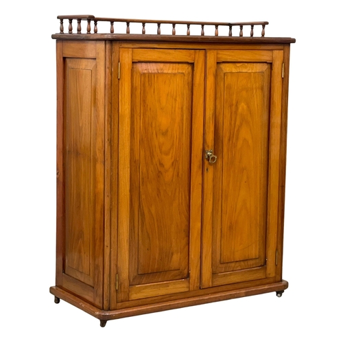 956 - A Victorian Walnut storage cabinet with interior shelves and gallery. 90x43x115cm