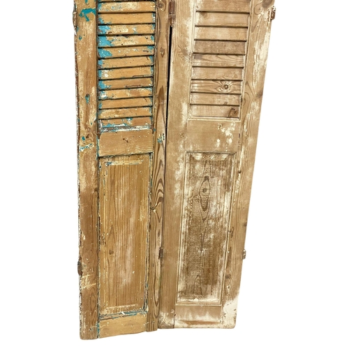 968 - A pair of large 19th century French pine shutters. 207.5cm