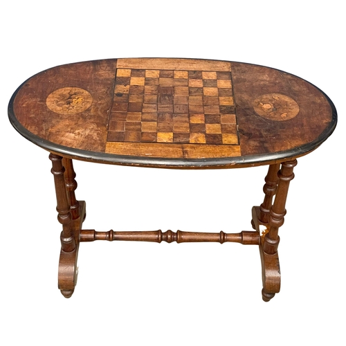 987 - A Victorian games table. 91x49x66cm