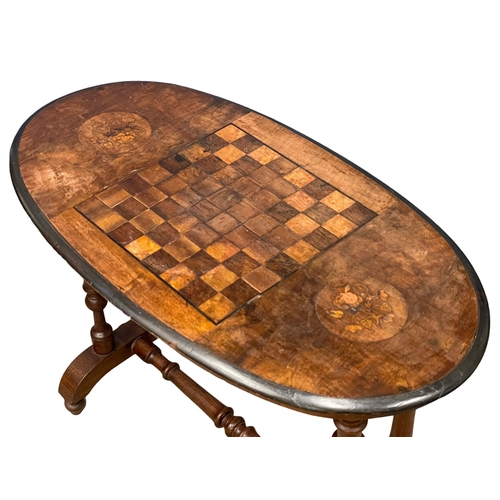 987 - A Victorian games table. 91x49x66cm