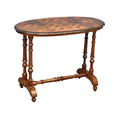 987 - A Victorian games table. 91x49x66cm