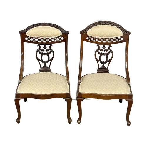 990 - A pair of Edwardian mahogany parlour nursing chairs.