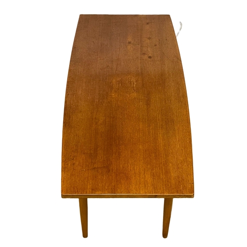 992 - A Mid Century teak coffee table. 107.5x46x46cm.