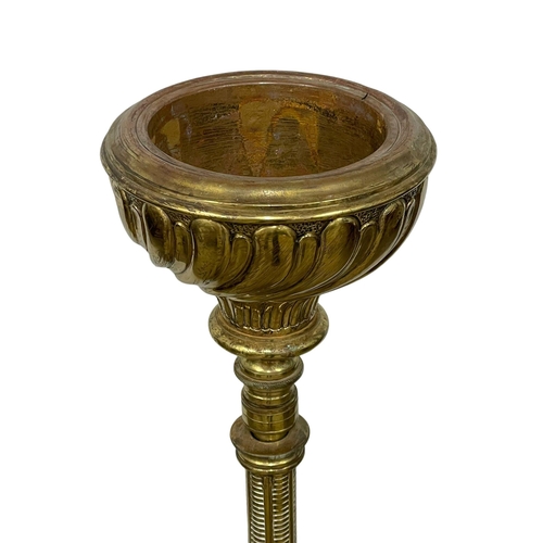 849 - A large Victorian brass candle stand on lion paw feet