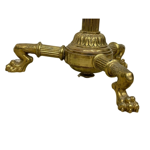 849 - A large Victorian brass candle stand on lion paw feet