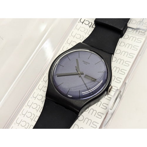 A Swatch Black Rebel Again Silicone Watch in case