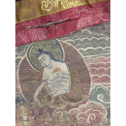 768 - A vintage silk Buddhist Thangka. 86x118cm