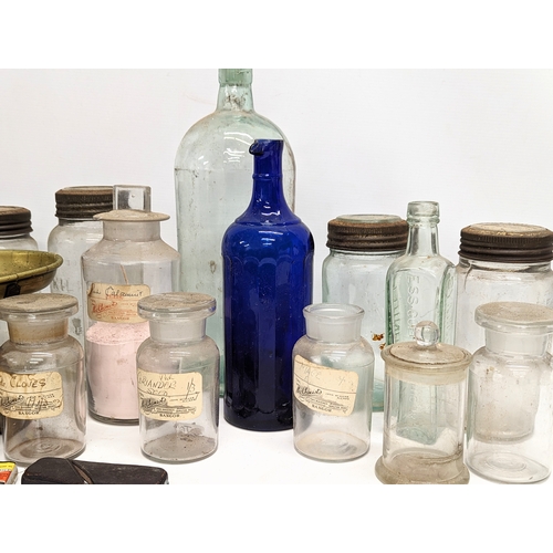 770 - A sundry lot of 19th / 20th century glass bottles and jars, with a set of brass Avery scales.