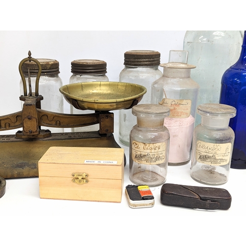 770 - A sundry lot of 19th / 20th century glass bottles and jars, with a set of brass Avery scales.