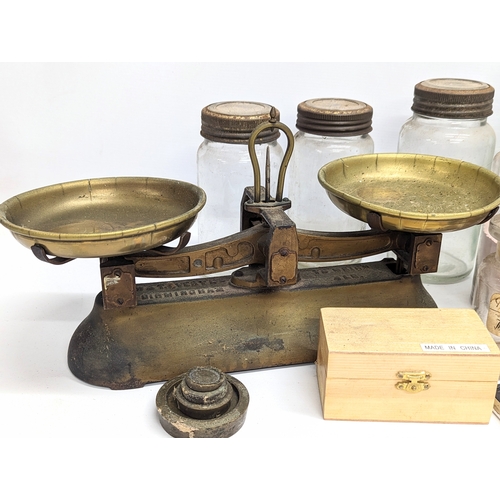 770 - A sundry lot of 19th / 20th century glass bottles and jars, with a set of brass Avery scales.