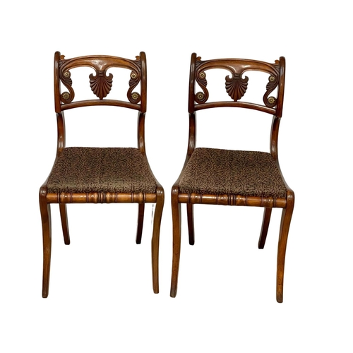 1075 - A pair of Regency mahogany side chairs on sabre legs. Circa 1810.