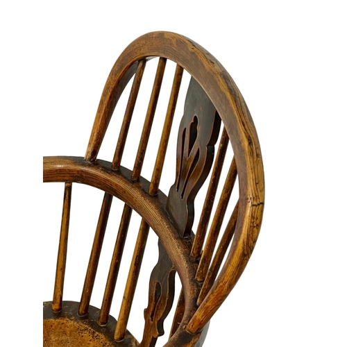 1087 - A mid 19th century Elm Windsor armchair.